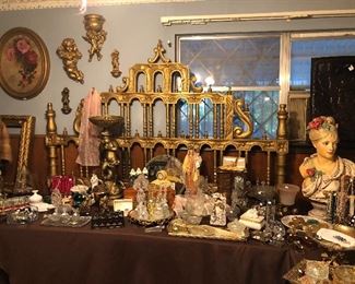 Fun vintage headboard, large nude bust, cupid light, and lots of vintage Irice perfume bottles, jewelry boxes, glass vanity mirrors and more.