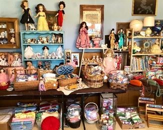 Kids room full of dolls, antique 1812 sampler, clocks, books, sewing notions and fabric, and tea sets.  Madame Alexander dolls.
