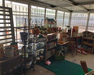 Vintage lunchboxes, tin doll house with furniture, toy cars and trucks, vintage pots.