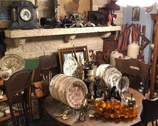 The Texas room with Stag painting, oak table and chairs, lots of Vernon Kilns Texas plates, Aladdin ruby red oil lamp, Phippen horse trophy, and more.