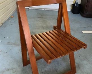 One of four folding wood chairs