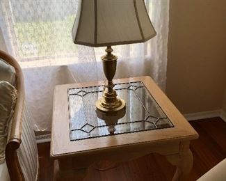One of two lamp tables with glass inserts.  Also show is one of two brass base lamps
