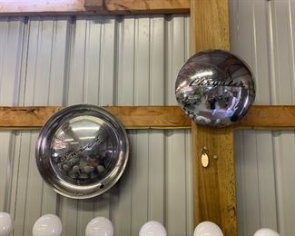 Vintage hub caps including Buick, Chrysler