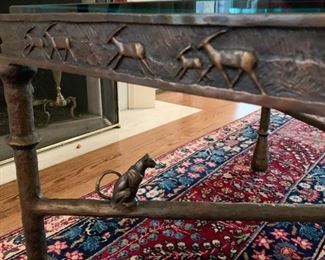(detail view of cocktail table, leopard on crossbar)