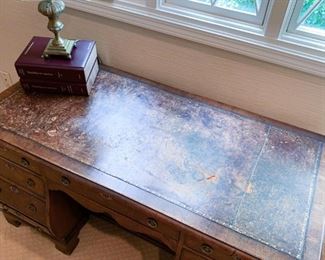 (detail view of desk, damage on the top)