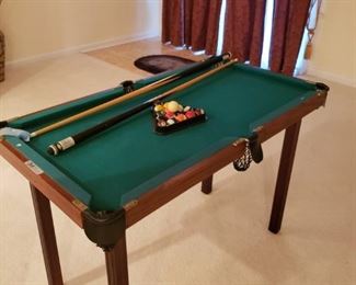 mini pool table and 4 sticks