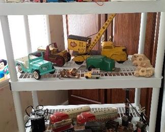 Vintage Ny-Lint lift truck, Tonka Jeep, Caterpillar tractor, Magnetic crane, vintage “O” scale Santa Fe train engines, cars, flat beds, railroad crossing signs, Aurora slot car track and cars, Fisher Price family A-frame house, Playschool camper, Fisher Price electronic bus, Playschool Holiday Inn with accessories, Fisher Price people, Playschool people, Fisher Price pull telephone