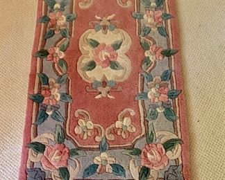 $75 Floral rug 51" long by  25" wide