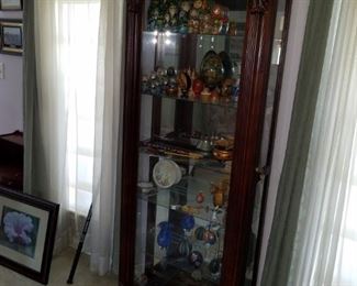 detailed wooden curio cabinet, with glass shelves, front door slides both ways for access, with lock & key. 76" tall x 31" wide x 12" deep