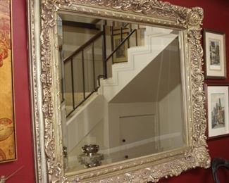 Large silver colored entry mirror.