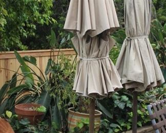 Two patio umbrellas and stands.