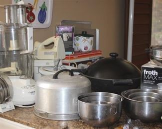 Kitchen items including Cuisinart food processor. hand mixer, frother, meat slicer, little dipper crock pot.