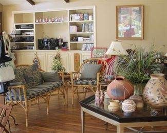 Bamboo and rattan furniture, large coffee table, Native American Indian items, stereo components, CDs, DVDs, art and table lamps.