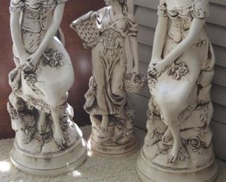 Three indoor outdoor lady statues.