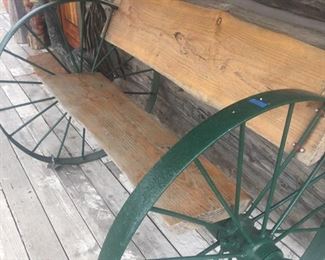 bench made of wagon wheels and slabs wood