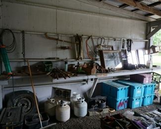 Propane tanks, one with heater, storage boxes, tons of misc items.