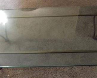 Wrought iron coffee table with glass top 60" by 30" Asking $150.00. Glass has some chipping on edge