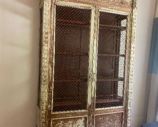 Antique (restored) French breakfront c. Mid 19th century Featuring beveled glass shelving and gorgeous floral relief detail