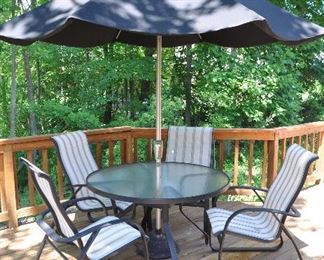 7 PIECE OUTDOOR PATIO SET BY TROPITONE INCLUDES A 48" ROUND OBSCURE ACRYLIC TABLE, FOUR SLING CAST ALUMINUM CHAIRS (ONE CHAIR HAS BEEN PATCHED) UMBRELLA AND UMBRELLA STAND. OUR PRICE $500.00
