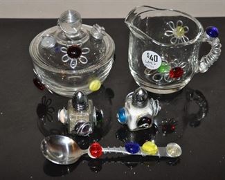 ADORABLE STONE AND SILVER METAL DECORATED GLASS CREAM, SUGAR, SALT AND PEPPER HOLDERS WITH A MATCHING TEASPOON. SOLD AS A SET FOR $40.00