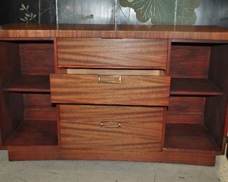 THERE ARE FOUR DRAWERS IN THE CENTER OF THIS PIECE ALONG WITH TWO CABINETS, ONE ON EACH SIDE. EACH CABINET HAS TWO SHELVES.  