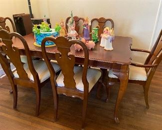 Dining table with 6 chairs and two extra leaves.