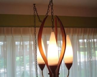 Living Room:  The  Mid-Century Modern REMBRANDT hanging lamp is teak/walnut and brass.  The three white frosted glass shades are each 11" tall and are entwined in the three 20" tall wooden scrolls.  Just put a couple of hooks in your ceiling, hang the chain, plug it in, and you have instant COOL!