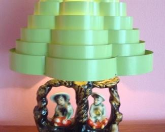 Living Room:  The 1950's Asian-scene ceramic lamp shows two children sitting in a tree.  The metal Venetian blind shade is an unusual green.