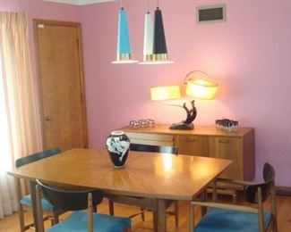 Dining Area:  The Mid-Century Modern dining table as shown measures 40" x 62" but includes three 12" leaves and pads.  The mid-century chairs are priced separately from the table.