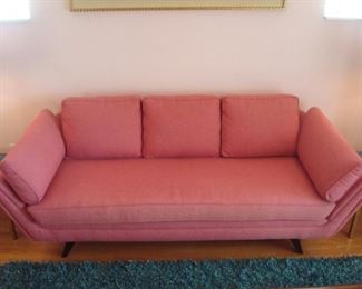 Living Room:  The custom upholstered  Mid-Century Modern-style sofa is 87" wide with a 29" high back.  It has a single bench detached cushion, three detached back cushions, and two side pillows.  Notice the flared sides and raised legs.