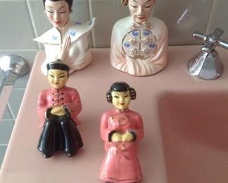 Bathroom:  Asian figures are displayed on the sink.  The two small ones in the front are shelf sitters.