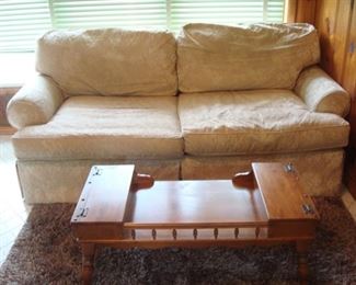 Family Room: A newer cream color sofa with two seat cushions and rolled arms measures 86" long. Closer photos of the table and rug follow.