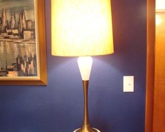 Bedroom:  A very tall (50" to top of lamp shade) Mid-Century Modern creamy white and brass lamp is displayed on the dresser.