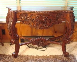 Family Room:  A closer photo of the carved wood console table better shows the details.  It measures 48" wide x 19" deep x 31" tall.  (Note:  It is not an antique but very handsome!)