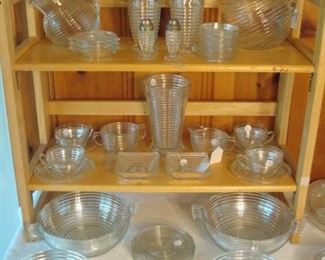 Family Room:  The ribbed "Manhattan" glass includes:  water and juice pitchers; tumblers; salt & pepper set; cups & saucers; cream & sugar; winged bowls; ashtrays; candle holders and more!    Each piece is priced OR priced as a set (e.g., set of coasters; per bowl; per dinner plates) so you can complete your current collection without having to purchase multiples.