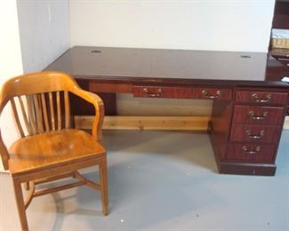 Lower Level:  A vintage office chair is n front of a cherry desk.