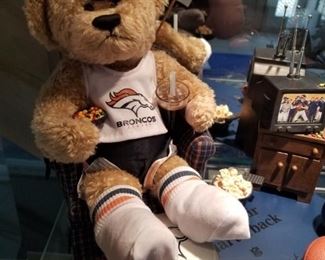 BRC-1 ($75) "Armchair Quarterback" by the Danbury Mint.  So cute! Comes with Bronco bear holding snacks and a drink.  He is watching the game on the Tv.  Comes with lots of pieces to create your own scene! 