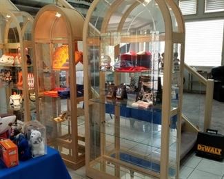 3 large glass lighted display cabinets with oak trim and mirrored backs.  Each has glass shelves with beveled notches for plates.  Items enter from doors on the sides.  Arched tops with removable panels for the top shelf.  Middle unit (smaller) measures 30"w x 12.5"d x 79"h ($150).  The other two larger units each measure 40"w x  14"d x 83"h ($200 each)