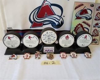 AV-2 ($60) 1995-96 Stanley Cup Avalanche display with 5 pucks, 6 hat pins and metallic stickers.