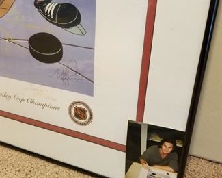 AVB-2 ($100) Signed Looney Tunes Avalanche work of art.  Bugs as an Avalanche player in this mixed media of Lithography and serigraphy.  Signed by both of the Mckimson Brothers from WB Looney Tunes.  PLUS, signed by Joe Sakic and Mike Ricci with photos of them signing this.  Comes with COA on the back.  1996 Stanley Cup.  Comes framed, measures 24" x 28".