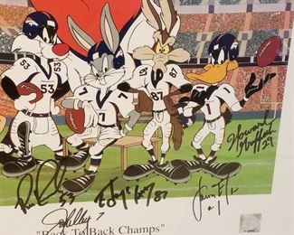 DC-7 ($100) Looney Tunes Cel with Denver Broncos for Superbowl XXXIII (Denver/Atlanta) Limited edition of 500.   Signed by many players including Terrell Davis (pic of him signing on back).  Comes framed and with COA.  Measures 27.5" x 24.5"h.