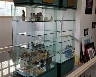 WALT DISNEY shelf display units!  3 available.  All the same size 38"w x 23"d x 80"h.  Each has a key to lock your treasures.  Side door entry on both sides.  Locking drawer at the base.  Official Disney logo at the top.  These are a pale green in color.  Clear glass front and back.  We have 3 available, $600 each.  No flaws noted.