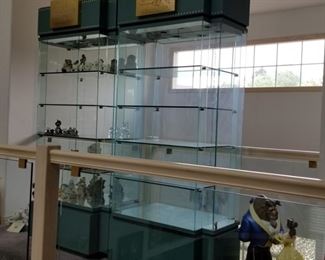 WALT DISNEY shelf display units!  3 available.  All the same size 38"w x 23"d x 80"h.  Each has a key to lock your treasures.  Side door entry on both sides.  Locking drawer at the base.  Official Disney logo at the top.  These are a pale green in color.  Clear glass front and back.  We have 3 available, $600 each.  No flaws noted.