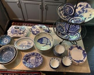 Blue and white serving pieces including a set of Asian fish bowls