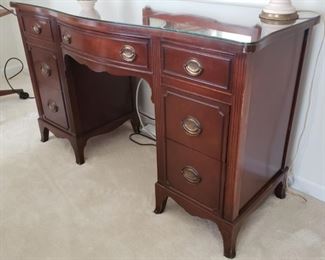 Desk with glass topper...50" wide x 20" deep x 30" tall. There is some discoloration on the left side of the desk in the front.