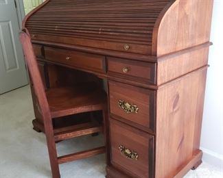 Roll-top desk with chair. 48" wide x 44" high x 20" deep. Minor dings from use.