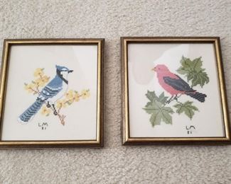 Each piece of framed needlework is 8" x 8"
