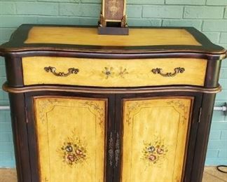 Painted cabinet with floral embellishmenet