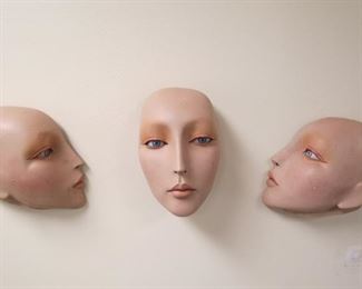 Vintage wall hanging mannequin faces.