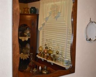 Beautifully Framed Wall Mirror featuring Scalloped edging framing the Mirror.